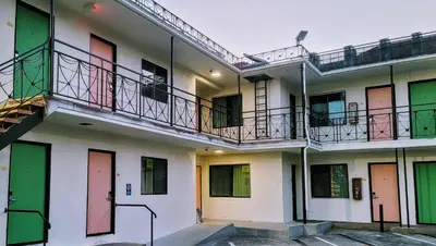 a row of apartment buildings with colorful doors and balconies at The Bell Vista in Burbank