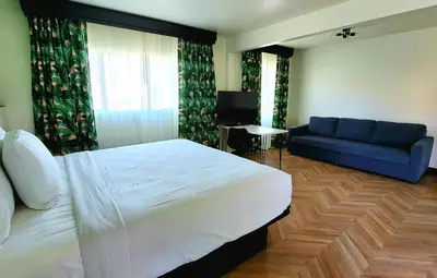 a bedroom with a bed and a blue couch at The Bell Vista in Burbank