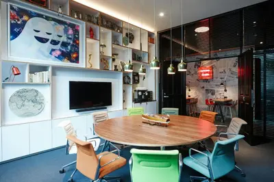 a dining room with a wooden table and chairs at citizenM Los Angeles Downtown in Los Angeles
