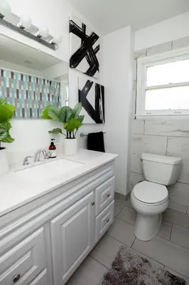 a white bathroom with a toilet and a sink at Heartwell Park Beauty Long Beach in Long Beach
