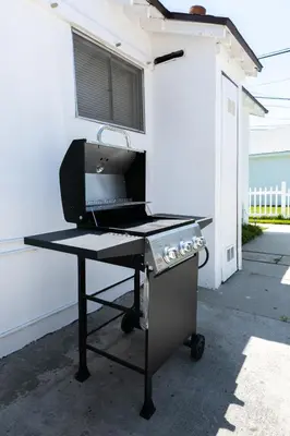 a grill sitting on top of a table in front of a building at Heartwell Park Beauty Long Beach in Long Beach