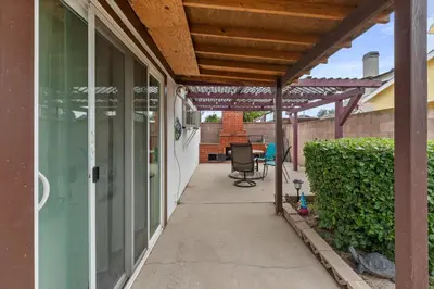 a patio with a wooden pergola on a house at Heartwell Park Beauty Long Beach in Long Beach