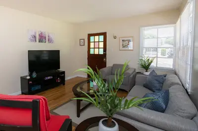 a living room with a couch and a tv at Heartwell Park Beauty Long Beach in Long Beach