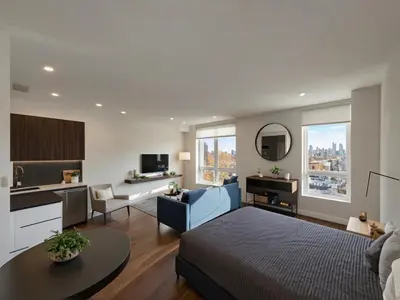 a room with a bed and a living room with a kitchen at Modern Luxury Apartments in the Heart of Los Angeles in Los Angeles