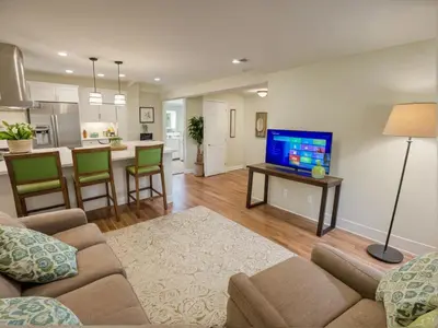 a living room with a couch and a tv and a kitchen at Modern Luxury Apartments in the Heart of Los Angeles in Los Angeles