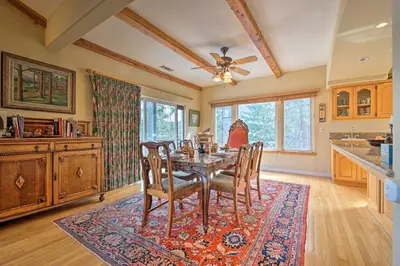 a dining room with a table and chairs at Wraparound Deck Woodland Cabin in Lake Arrowhead in Lake Arrowhead