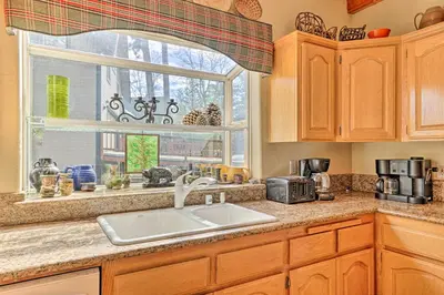 a kitchen with a sink and a window at Wraparound Deck Woodland Cabin in Lake Arrowhead in Lake Arrowhead