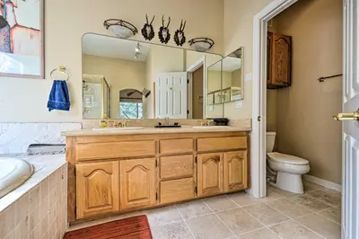 a bathroom with a sink and a toilet and a mirror at Wraparound Deck Woodland Cabin in Lake Arrowhead in Lake Arrowhead