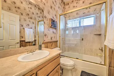 a bathroom with a sink and a toilet and a shower at Wraparound Deck Woodland Cabin in Lake Arrowhead in Lake Arrowhead