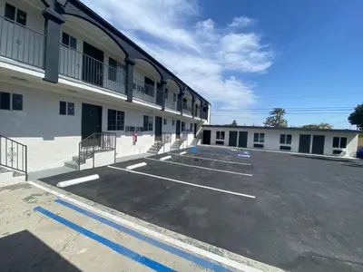 an empty parking lot in front of a building at SOFI MOTEL in Los Angeles