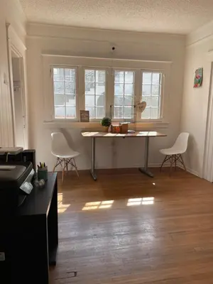 a living room with a table and chairs in it at The California - Hollywood in Los Angeles