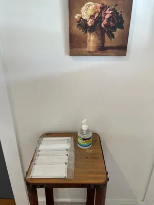 a small wooden table with a vase of flowers on it at The California - Hollywood in Los Angeles