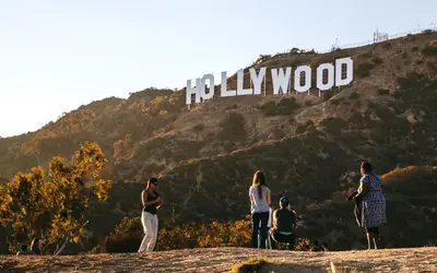 a group of people standing in front of the hollywood sign at The California - Hollywood in Los Angeles