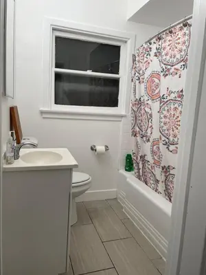 a bathroom with a sink and a shower curtain at The California - Hollywood in Los Angeles