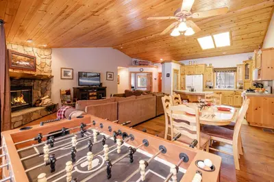 a living room with a table and a chess board at Little Cubs Cabin #1986 by Big Bear Vacations in Big Bear Lake