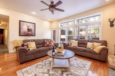 a living room with a couch and a table at The Grand Chalet #1989 by Big Bear Vacations in Big Bear Lake