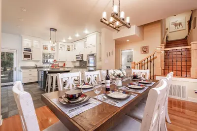 a kitchen and dining room with a wooden table and chairs at The Grand Chalet #1989 by Big Bear Vacations in Big Bear Lake