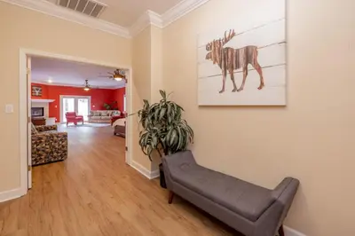 a living room with a couch and a painting on the wall at The Grand Chalet #1989 by Big Bear Vacations in Big Bear Lake