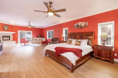 a bedroom with red walls and a bed and a couch at The Grand Chalet #1989 by Big Bear Vacations in Big Bear Lake