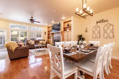a dining room and living room with a table and chairs at The Grand Chalet #1989 by Big Bear Vacations in Big Bear Lake