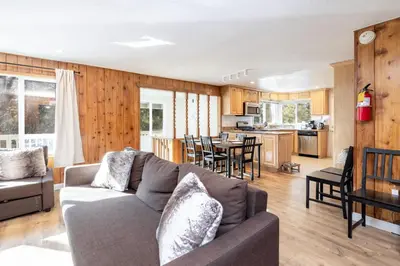 a living room with a couch and a kitchen at Conklin Paradise #1993 by Big Bear Vacations in Big Bear Lake