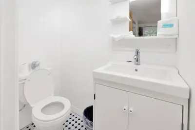 a white bathroom with a toilet and a sink at Conklin Paradise #1993 by Big Bear Vacations in Big Bear Lake