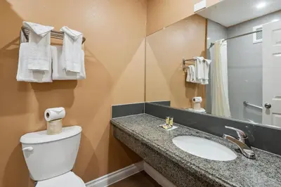 a bathroom with a toilet and a sink and a mirror at Hotel H-Wood in Los Angeles