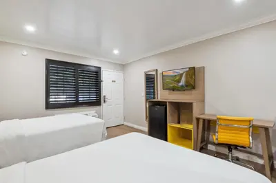 a bedroom with two beds and a desk at Hotel H-Wood in Los Angeles