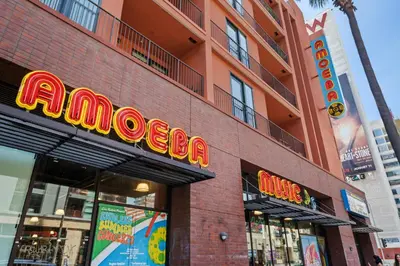 a red brick building with a neon sign on it at Hotel H-Wood in Los Angeles