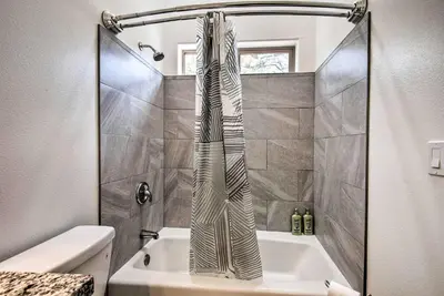 a bathroom with a shower with a vase on the sink at Pine Mountain Club Villa with Sauna, Deck and Views! in Pine Mountain Club