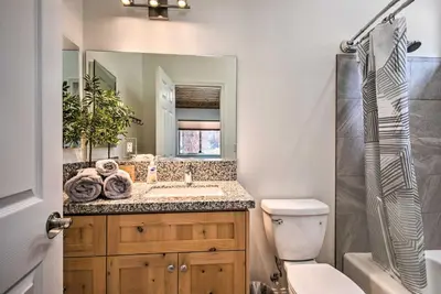 a bathroom with a sink and a toilet and a mirror at Pine Mountain Club Villa with Sauna, Deck and Views! in Pine Mountain Club