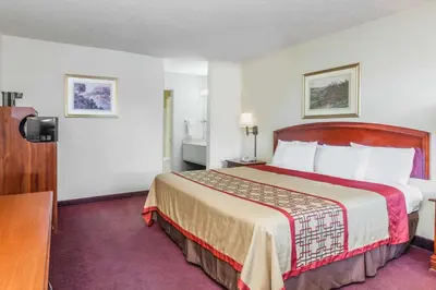 a hotel room with a large bed in it at Super 8 by Wyndham Bakersfield/Central in Bakersfield