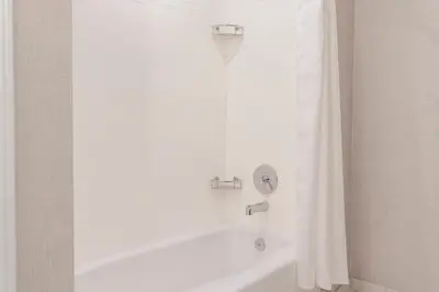 a white bath tub with a shower curtain in a bathroom at Residence Inn by Marriott Loma Linda Redlands in Redlands