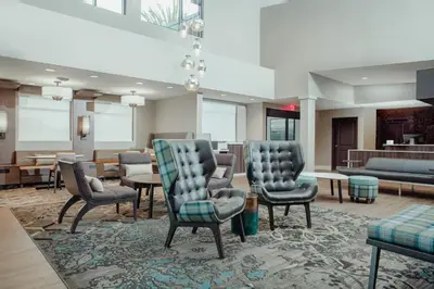 a lobby with chairs and tables and a living room at Residence Inn by Marriott Loma Linda Redlands in Redlands