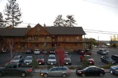 a large building with cars parked in front of it at Robinhood Resort in Big Bear Lake