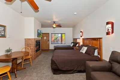 a living room with a bed and a couch at Robinhood Resort in Big Bear Lake