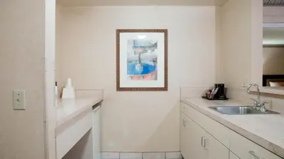 a kitchen with a sink and a picture on the wall at Studio 6 Anaheim Hills CA in Anaheim