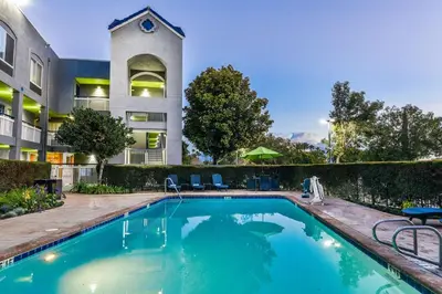 a swimming pool in front of a building at SureStay Hotel by Best Western Ontario Airport in Ontario