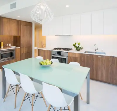 a kitchen with a blue table and white cabinets at Luxury Highrise Living Downtown LA in Los Angeles