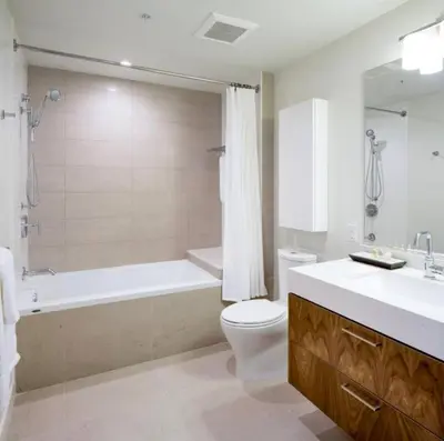 a bathroom with a tub and a toilet and a sink at Luxury Highrise Living Downtown LA in Los Angeles
