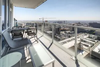 a balcony with chairs and tables on a building at Luxury Highrise Living Downtown LA in Los Angeles