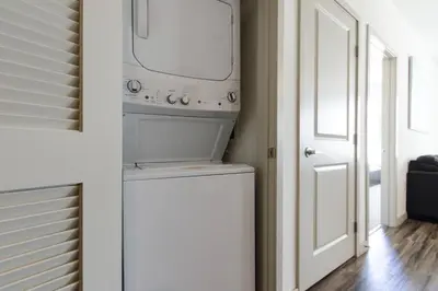 a washer and dryer in a room with a door at Luxury Highrise Living Downtown LA in Los Angeles