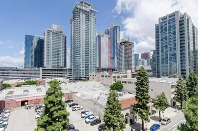a city with cars parked in a parking lot at Luxury Highrise Living Downtown LA in Los Angeles