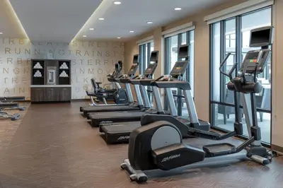 a row of treadmills in a gym with windows at Residence Inn by Marriott Lancaster Palmdale in Lancaster