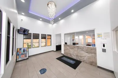 a lobby of a building with a chandelier at Travelodge Inn & Suites by Wyndham West Covina in West Covina