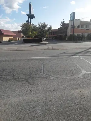 an empty street with a star painted on the road at Evergreen Inn in Covina