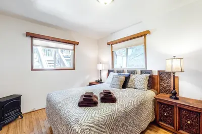a bedroom with a bed with two towels on it at Alpine Dream in Crestline