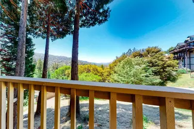 a view from the deck of a house with trees at Alpine Dream in Crestline