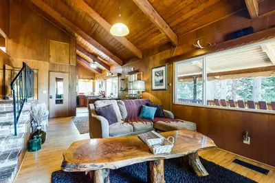 a living room with a table and a couch at Alpine Dream in Crestline