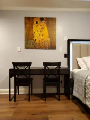 a bedroom with two chairs and a painting on the wall at Hotel Europa in Smeltzer